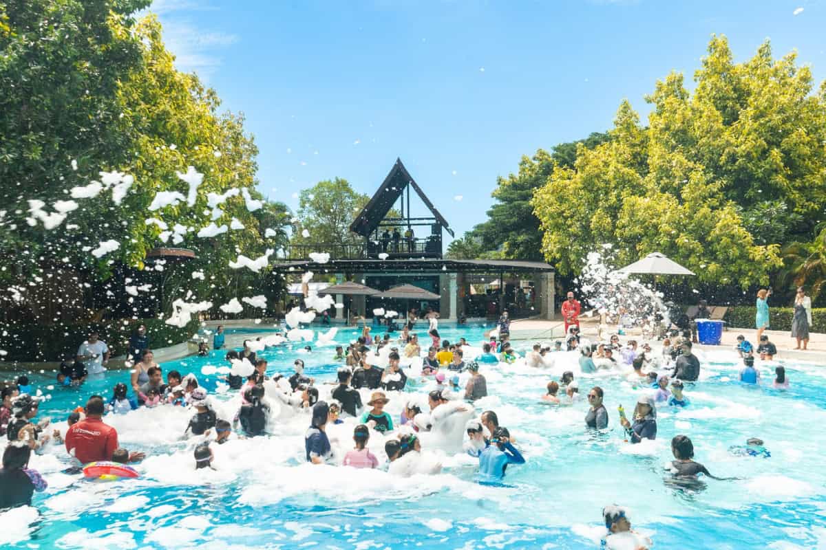 waterpark goers enjoying foam party in pool