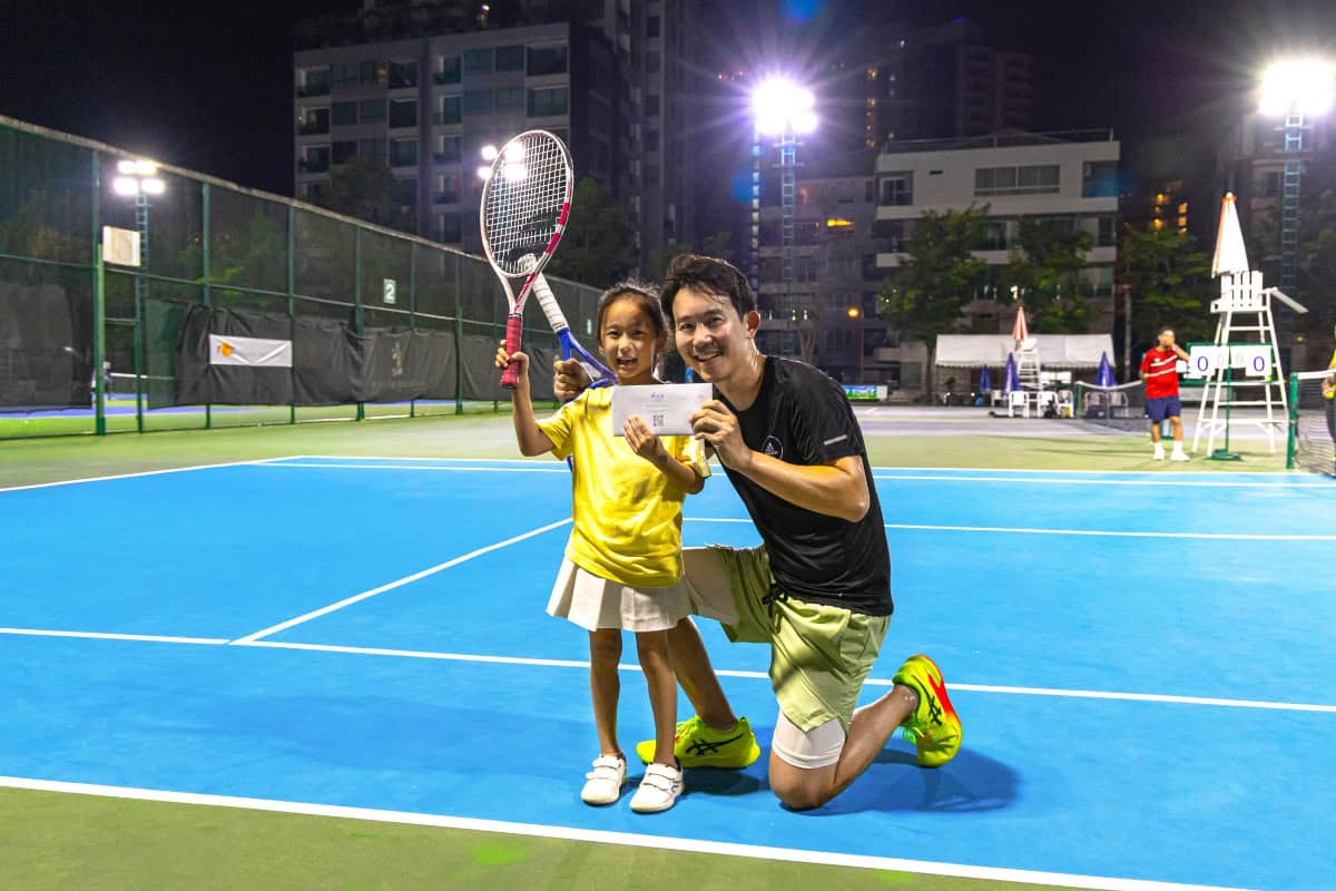 victorious young tennis player posing with Royal Cliff CEO